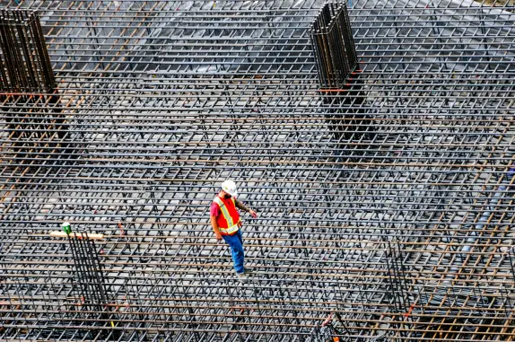 Site engineer inspecting rebar reinforcement before concrete pour