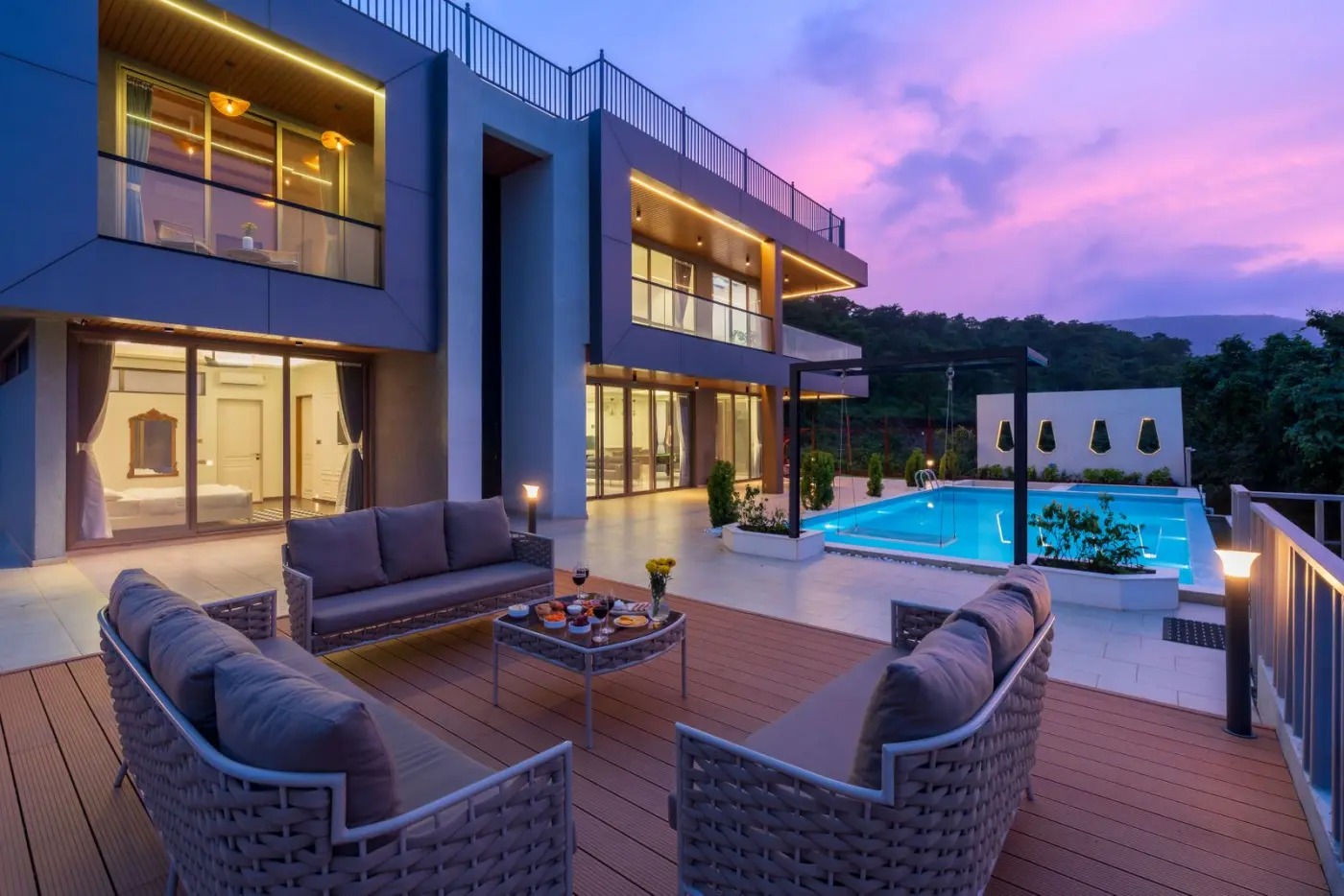 Premium Avatar Builders villa with pool lit up at twilight