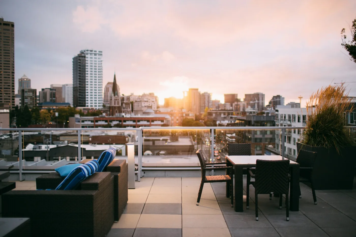 Rooftop lounge seating with city skyline at sunset